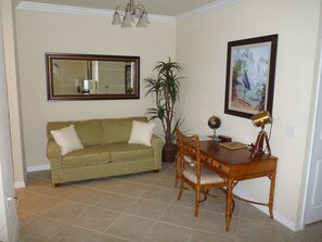 Den area with additional seating and desk