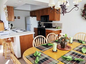 Hand picked decorations adorn the full sized dining room adjacent to kitchen.