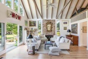 Living room with vaulted barn ceiling,   wood burning fireplace.
