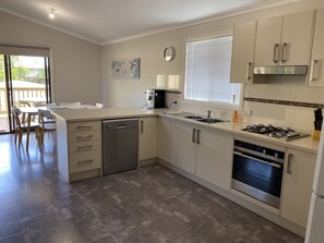 Modern kitchen with dishwasher and walk in pantry