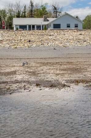 Front of cottage from sand beach at low tide