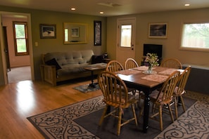 Open concept living area with quality futon that folds out to queen size bed