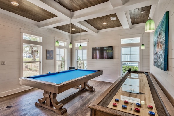 Pool table and shuffleboard table in main living room, french doors to pool