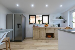Well equipped kitchen with large American style fridge freezer