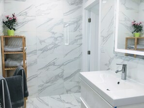 Master Bath #2: Wall-mount vanity cabinet and porcelain sink; towels provide