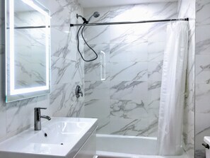 Master Bath #2: Wall-mount vanity cabinet and porcelain sink; towels provided