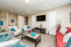 Main level family room with BIG flat screen TV & electric fireplace below