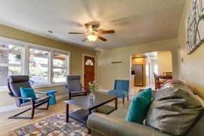 The spacious living room looks out over the covered porch