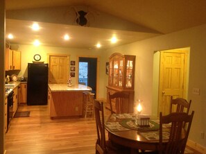 Kitchen: View into kitchen from living room featuring an antique dining room set