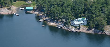 Aerial view, 1400 ft of Water Frontage, Plane port in back 