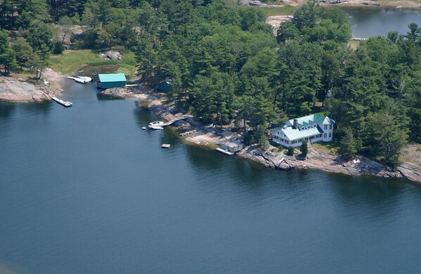 Aerial view, 1400 ft of Water Frontage, Plane port in back 