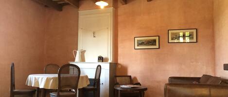 Living/dining room with provencal ceilings, original tiles, and fireplace.