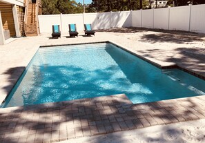 Large pool with two benches for relaxing in the pool.