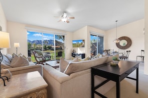 Sliding doors in living room area and dining room. Desk looks out to the view