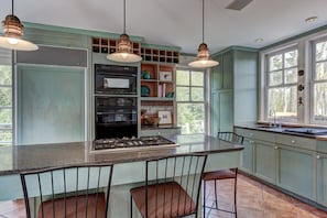 Spacious kitchen with views of both ponds and island seating.