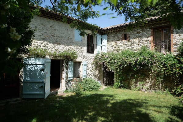 Courtyard and  main house (blue doors and blinds). Front door into the kitchen.