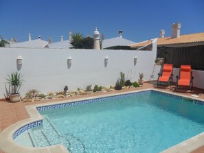 Pool and reclining sun loungers