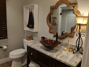 Granite counter, glass sink, ADA toilet