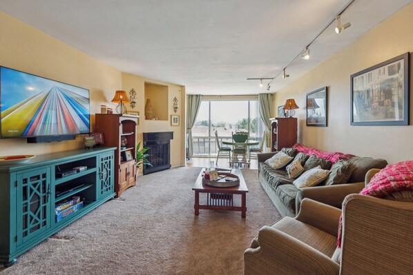 Relax in a sunlit living room with, smart TV & peaceful balcony views. 