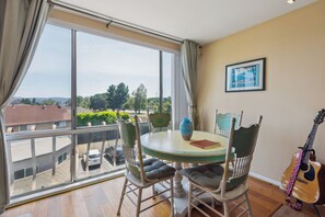 Bright and airy dining nook with nature views and vintage charm.