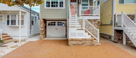 Street view of home, front porch and one car driveway