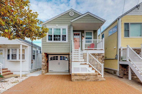 Street view of home, front porch and one car driveway