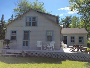 Side View of  Boat Cottage with Table and  Extended Porch Dining Area