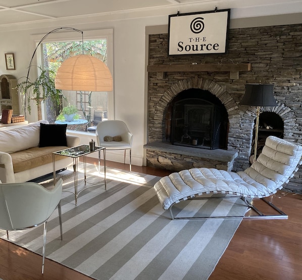 Relaxing sun room with wood burning fireplace.