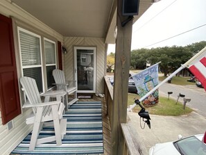 Sitting area by front door.  Two comfortable polywood chairs and table.  