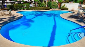 Enjoy refreshing pools under swaying palm trees under Palm Springs blue skies.