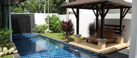 Swimming pool with sala, jacuzzi at far end
