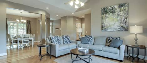 Spacious Family Room with adjacent Dining Room and Front Door beyond