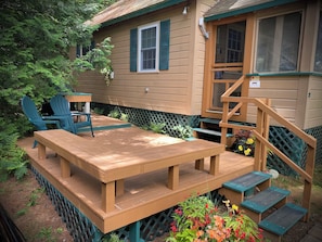 Deck with bench seating and Adirondack chairs.
