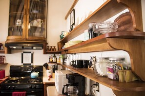 Kitchen view. Stove, coffee maker, local coffee, tea and microwave