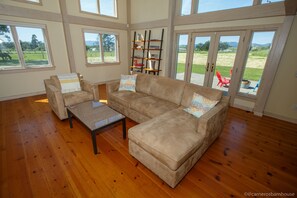 Soaring ceilings in great room with loft and dining area; relax and read a book