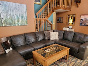 Spacious living room with TV and plenty of seating.