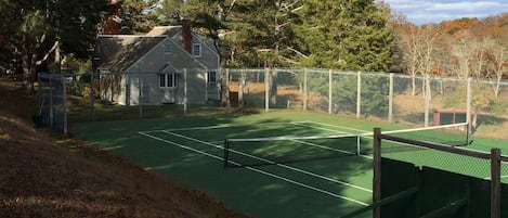 A view of the tennis court and house