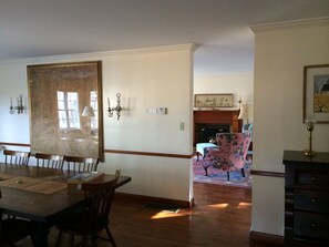 A view of the dinning room table that seats twelve and the living room beyond