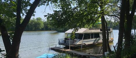 Boat is docked on six acres of private wooded property.