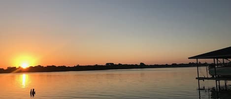 Sunrise over Granbury lake with part of our boat house in the picture