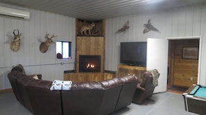 cozy area featuring tv and fireplace. Doorway leads to bedrooms