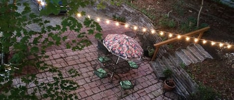 Patio as seen from above. Seating,flowers,fire pit, fireplace, view of  Lookout