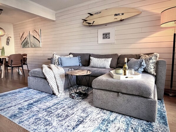 The living room features a sectional that can be configured into a bed.