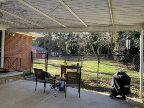 small table and chairs under carport