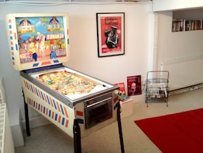 Basement playroom/living room with pinball and table football.