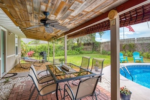 The back porch has dining, hammock, grill and access from the living space and master bedroom.