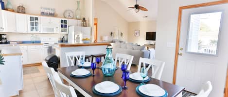 Open concept living, with dining seating for 8.  Six chairs and two bar stools. 