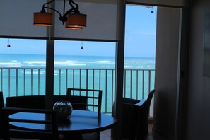 Ocean view from dining area and balcony at dusk.
