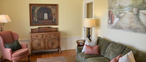 Living room with Mitchell Gold sofa sleeper, custom furniture & original artwork