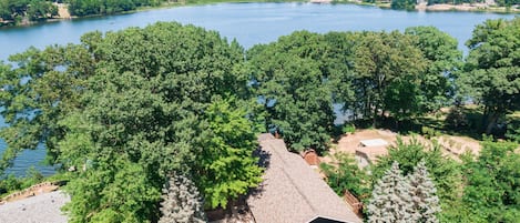 The Cedar Lodge (partially hidden by trees) sits atop beautiful Stone Lake.